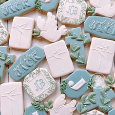 cookies decorated with blue and white icing are arranged on a table