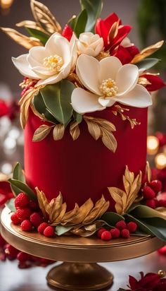 a red cake with white flowers and leaves on the top is surrounded by berries and greenery