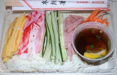 a tray filled with assorted veggies and dipping sauce