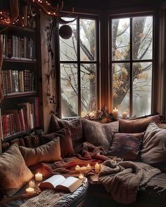 a living room filled with lots of books and candles