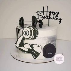 a birthday cake with an image of a man's body and dumbbells on it