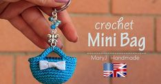 a crocheted mini purse keychain with a bow on it