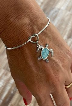 This stainless steel bangle is One Size Fits All. Turtle Charm is Silver Plated. Adjustable Nickel-free Stainless Steel Bangle, Adjustable Stainless Steel Nickel-free Bangle, Silver Stackable Jewelry For Beach, Stackable Silver Jewelry For The Beach, Adjustable Stackable Stainless Steel Jewelry, Eternity Knot, Open Cuff Bracelet, Turtle Charm, Stainless Steel Bangles