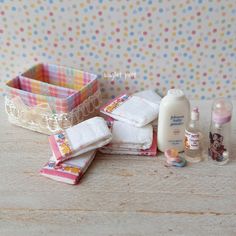 several baby products are laid out on a table with polka dot wallpaper in the background