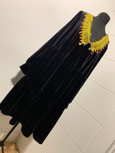 "This lush velvet black dress features traditional Afghan 'kuchi'(nomad) embroidery. This dress is suitable for all occasions. The dress is suitable for maternity. It's free size. Dimensions: Length:39\" Sleeve Length:25\"" Traditional Black Tunic Dress, Traditional Velvet Dress For Festivals, Traditional Black Festival Dress, Traditional Black Dress For Festival, Black Folk Style Dress For Festivals, Folk Style Black Dress For Festivals, Velvet Bohemian Dress For Holiday Season, Long Sleeve Velvet Dress For Festivals, Festive Bohemian Velvet Dress