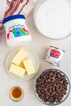 ingredients to make chocolate fudges laid out on a white counter top, including milk, sugar and butter