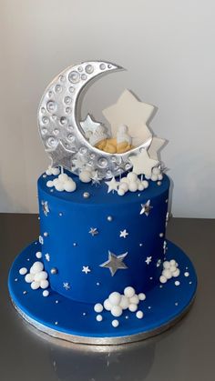 a blue cake with white stars and moon on top