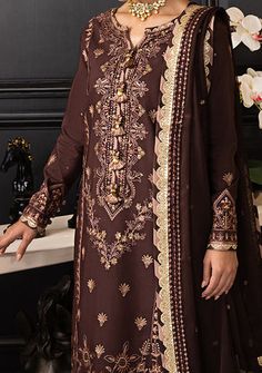 Journey through the pages of regality with this dark brown ensemble. An interplay of brown and mocha threads, kissed by gold sequins and antique zari, crafts a tale as old as time. The embroidered dupatta is the final chapter in this saga of splendor. Embroidered Front Center Panel On Lawn Silk. Embroidered Side Panels Right and Left For Front On Lawn Silk. Embroidered Border For Front On Lawn Silk. Embroidered Back, and Sleeves With Border On Lawn Silk. Embroidered Border For Front and Back Chaak On Lawn Silk. Embroidered Dupatta On Chiffon With Two Side Borders. Dyed Lawn Silk For Trouser. Color: There might be slight color variation due to lighting and flashes while the photo shooting. The color may also vary because of different screen resolutions. Wash Care: Dry Clean Only. Side Borders, The Final Chapter, Asim Jofa, Tale As Old As Time, Readymade Saree, Embroidered Border, Embroidered Dupatta, Dark Brown Color, Clothing Websites