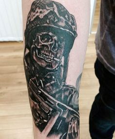 a man with a tattoo on his arm holding a knife and skull in the other hand