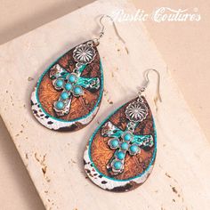 Rustic Couture's Western Cross Teardrop Dangling Earring Material：Silver-tone metal and turquoise stones Size：3.2″（H）×1.6″(W) Western Cross, Turquoise Stones, Jewelry Diy, Contrast Stitch, Turquoise Stone, Sugar Skull, Silver Tone, Dangle Earrings, Genuine Leather