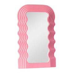 a pink mirror sitting on top of a white wall