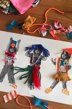 paper cut out of children's costumes on top of a piece of white paper