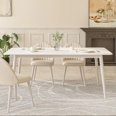 a white table with four chairs and a potted plant in the corner next to it