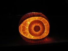 an eyeball shaped pumpkin sitting on top of a table