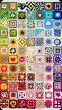 a large quilt with many different designs on it's sides, including squares and flowers