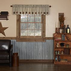 a living room filled with furniture and a star on the wall next to a window