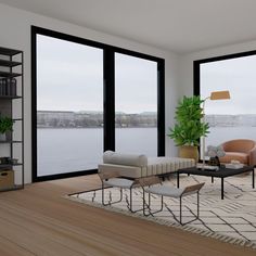 a living room filled with furniture and large windows overlooking a body of water in the distance