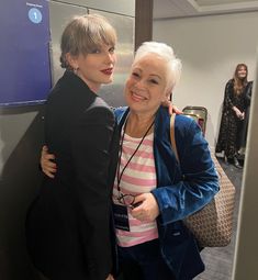 two women hugging each other in an office