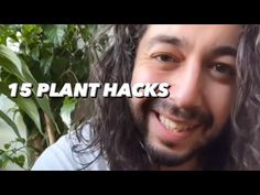 a man with long hair is smiling and has his face in front of the camera