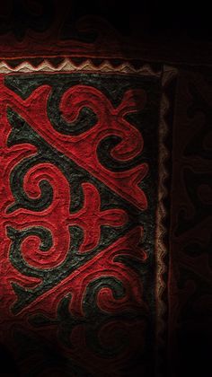 an artistic red and black design on fabric