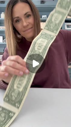 a woman sitting at a table with money in front of her