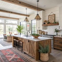 a large kitchen with an island in the middle and lots of counter space on one side