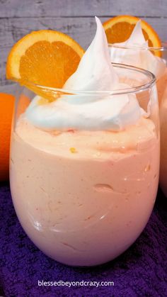 an orange dessert with whipped cream and fruit on the side is ready to be eaten