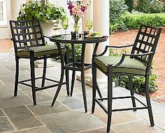 three chairs and a table on a patio