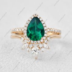 1.5ct Pear Shape Emerald Engagement Ring, Cluster Halo ring set, Yellow Gold Bridal Jewelry. May Birth Stone Promise Ring, 2Pcs ring set.. [{"Description"}] Main Gemstone- Name- Emerald (Lab Created) Shape - Pear Shape Stone Color - Green Birthstone- May Secondary Stone Name- Cz Diamond (Lab Created) Shape - Round Stone Color - Colorless Secondary Stone Tertiary Stone Name- Moissanite (Lab Created) Shape - Pear/Marquise Stone Color - Colorless Add this beautiful Ring in your accessories to make Pear-shaped Emerald Ring With Vvs Clarity For Wedding, Green Diamond Ring With Vs Clarity For Wedding, Moissanite Halo Ring, Halo Ring Setting, Bridal Gold Jewellery, Cz Diamond, Emerald Engagement Ring, Ring Set, Halo Rings