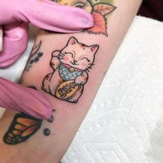 a woman with a cat tattoo on her arm