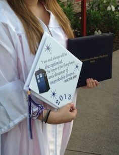 a girl dressed up as a doctor who is holding a book with writing on it