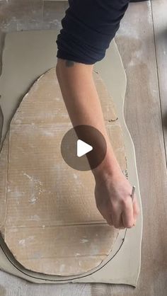 a person is making something out of cardboard