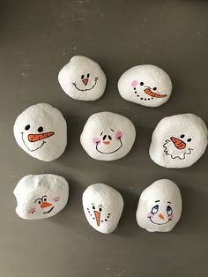 painted rocks with snowmen and carrots on them