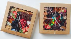 two boxes with different types of candies tied to each other and wrapped in brown paper