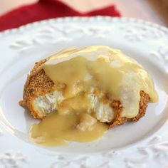 a white plate topped with food covered in gravy