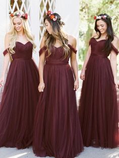 three women in long dresses with flower crowns on their head