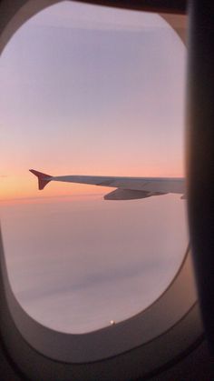 the view from an airplane window looking out at clouds