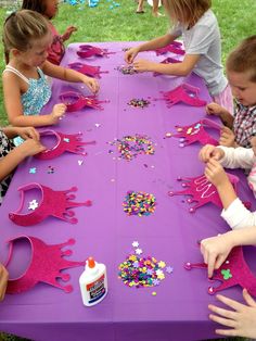 a purple table topped with lots of little kids