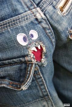 a pair of jeans that have been decorated with eyes and teeth