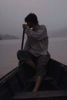 a man sitting in a boat on the water