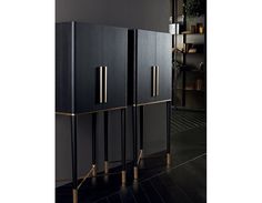 three black and gold cabinets in a room