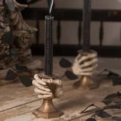 two candles sitting on top of a wooden table