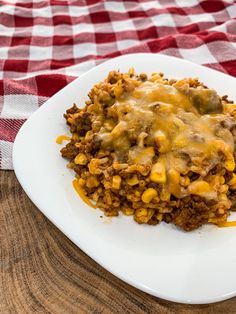 a close up of a plate of food on a table with a red and white checkered cloth