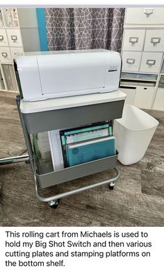 a machine that is sitting on top of a table next to a cup and some drawers