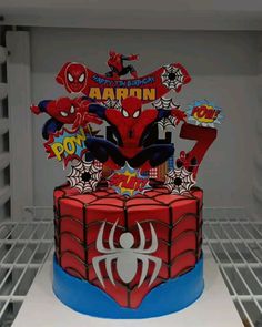 a spiderman themed birthday cake in a refrigerator