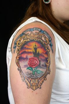 a woman with a tattoo on her arm and a rose in the middle of it