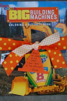 a book with an orange and white bow on it's front cover that says, big building machines coloring activity book