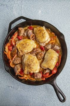 a cast iron skillet filled with meat and vegetables