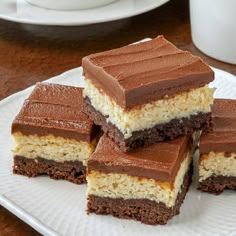 four pieces of cake sitting on top of a white plate