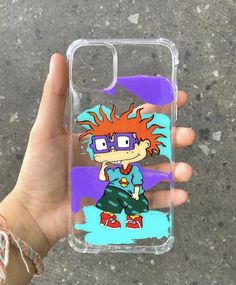 a person holding up a phone case with an image of a cartoon character on it